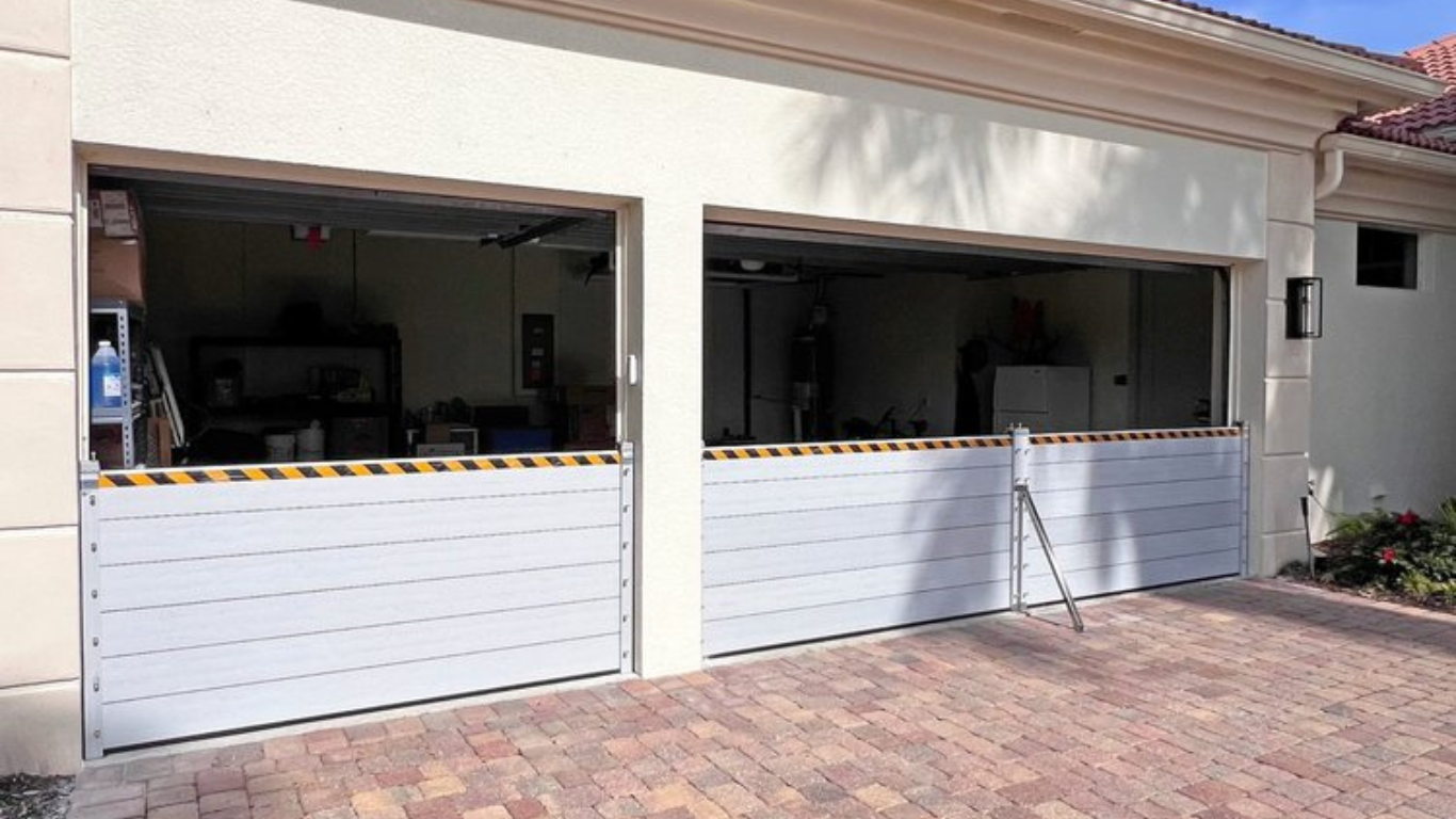 aluminum flood plank barriers installed across a two-car garage opening for flood protection.